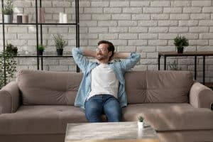man relaxing on comfy sofa